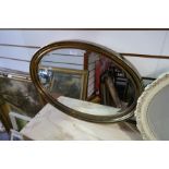 A bevelled edge oval mirror