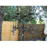 A wrought iron standing candelabra having 10 sconces