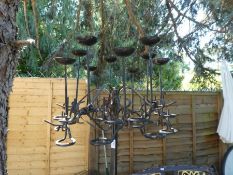 A wrought iron standing candelabra having 10 sconces