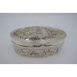 A silver Art Nouveau box, heavily decorated in foliate design having figure on lid. Oval design, dec