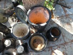 A quantity of black painted garden pots