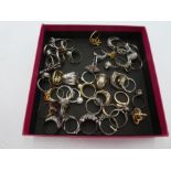 A quantity of modern silver dress rings to include pearl, moonstone, garnet and peridot examples