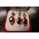 18ct yellow gold diamond and ruby earring and pendant set, with oval cut rubies surrounded by diamon