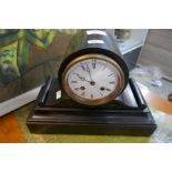 A slate mantle clock with white enamel dial