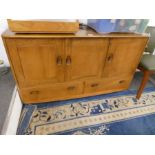 An Ercol elm sideboard having cupboards with 2 drawers below, 129cm