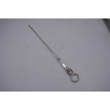 A long silver skewer terminating on a circular handle and shell design. A.F. maker's mark 38cm appro
