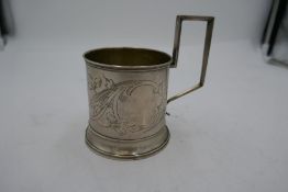 A Russian silver cup with decorative engraved floreated pattern, having interesting handle. Pos