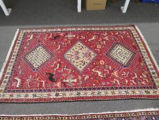 A geometric rug having red field with 3 central diamond medallions 206cm x 127cm