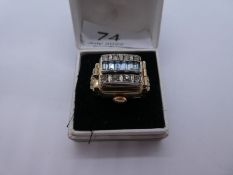 Gold plated watch ring mounted with a Orex 17 Ruby watch concealed by a panel, set blue and whit