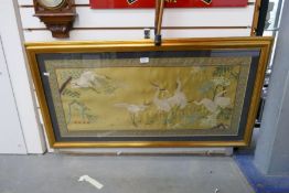 A framed and glazed Oriental embroidered silk picture depicting cranes, signed