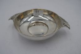 An Edwardian silver porringer, with hammered design body inside, and two pierced handles. Hallmarke