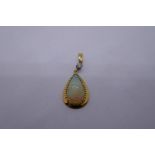 18ct yellow gold pendant with brilliant cut diamond suspending oval pear shaped Opal, marked 14K, 3.