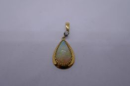 18ct yellow gold pendant with brilliant cut diamond suspending oval pear shaped Opal, marked 14K, 3.
