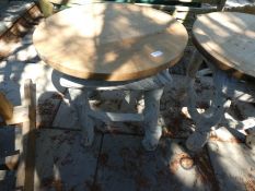A pair of circular garden tables on painted bases
