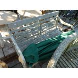 A regency style teak garden bench having open arms