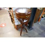 A reproduction circular side table having pierced decoration on four legs