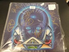A small collection of vinyl LPs including a signed Journey Frontiers, UFO, Lights Out, REO Speedwago