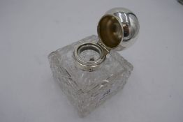 A charming Edwardian heavy cut glass and silver topped inkwell with spherical lid, hallmarked London