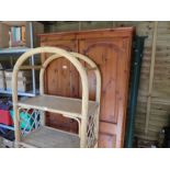 A modern pine wardrobe, a metal bedstead and a bookcase