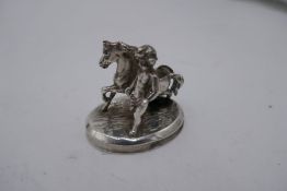 A miniature silver horse and figure with wings on oval base, possibly French, however mark worn. 5cm