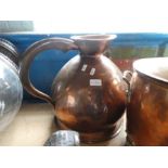 An antique large copper jug and an oval copper coal bin having riveted design on Lion Paw feet