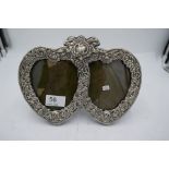 A high quality silver two heart photo frame, marked Sterling. Heavily decorated with repoussed flore