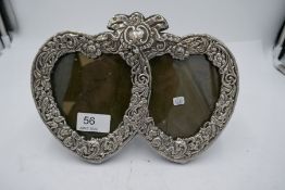 A high quality silver two heart photo frame, marked Sterling. Heavily decorated with repoussed flore