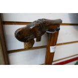 Two vintage walking stocks, one having a handle carved into a horse's head