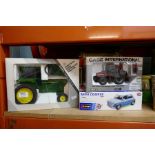 A selection of boxed die-cast vehicles, i.e. tractors and a boxed Mini Cooper car