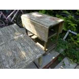A weathered teak garden trolley wood taken from HMS Powerful, and an oblong teak table
