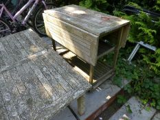 A weathered teak garden trolley wood taken from HMS Powerful, and an oblong teak table