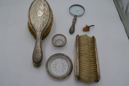 A quantity of silver items to include a pair of hand brushes, another pair of silver backed brushes.