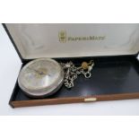 An ornate silver half hunter pocket watch with gold and silver coloured dial having Roman numerals.