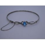 Contemporary 9ct white gold bracelet with central blue topaz, flanked with diamond chip, safety chai