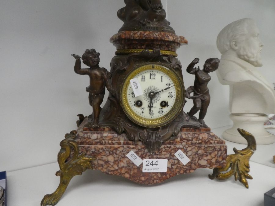 An antique French marble clock having spelter figure of lady above two cherubs, 62cm