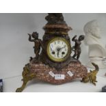 An antique French marble clock having spelter figure of lady above two cherubs, 62cm