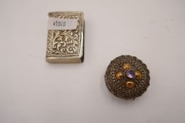 An ornate circular silver pill box marked 925, having decorative lid. Also with a white metal novelt