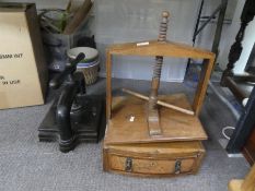 An antique wooden book press having one drawer base and a Victorian Iron book press