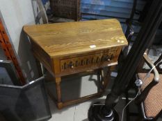 A repro oak side table having one drawer and 2 other items