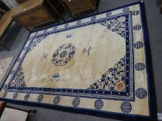 A modern Chinese blue and white rug having central motif surrounded by butterflies