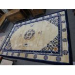 A modern Chinese blue and white rug having central motif surrounded by butterflies