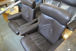 A Pair of Ekornes stressless brown leather reclining chairs having adjustable headrest with paid of