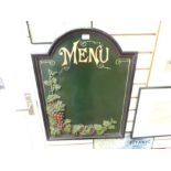 A menu board with grape and vine relief plus folding carved table