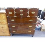 A military style chest of drawers in two parts having side handle and brass decoration, 104cms