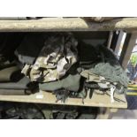 A quantity of Army uniforms to include Battle dress, Rucksacks, Boots etc, 2 shelves