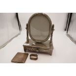 A silver plate dressing table mirror marked Vera Lucino, with ornate decoration and a draw. Also wit