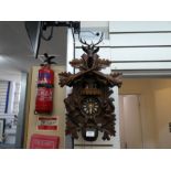 Swiss musical movement cuckoo clock with carved animal figures relief depicting squirrels and door
