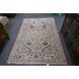 A modern geometric style rug with central motif, 218cm x 151cms