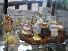 A selection of twelve Beswick Beatrix Potter figurines with tree-stump stand, mostly boxed