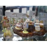 A selection of twelve Beswick Beatrix Potter figurines with tree-stump stand, mostly boxed